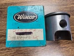 New Wiseco 2103P2 Kohler Piston - One Ring Missing. .020 Oversize. 67.87 Mm. Price: $50.00.